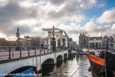 Canal Ring Area of Amsterdam - Seventeenth-century Canal Ring Area of Amsterdam inside the Singelgracht: The Magere Brug (Skinny Bridge) is one of the most famous bridges of...