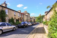 Saltaire, a Victorian model village - Saltaire: A row of 19th century small workers' houses, with the bell tower of the Saltaire United Reformed Church in the background. The... Saltaire, a Victorian model village - Saltaire: A row of 19th century small workers' houses, with the bell tower of the Saltaire United Reformed Church in the background. The...