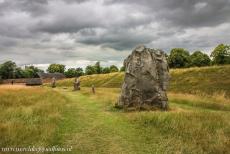 Avebury - Avebury Stone Circles and henge:  A part of the earthwork bank and the Outer Stone Circle of Avebury. Avebury consists of two inner stone...