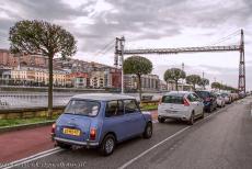 Vizcaya Bridge - A number of cars wait in line to cross the River Nervión in the hanging gondola of the Vizcaya Bridge. At the end of the long queue is our... Vizcaya Bridge - A number of cars wait in line to cross the River Nervión in the hanging gondola of the Vizcaya Bridge. At the end of the long queue is our...
