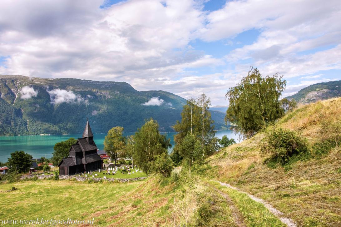 Urnes Stave Church - The Urnes Stave Church, in the background the Lustrafjord. The wooden church is surrounded by the breathtaking nature of Norway The... Urnes Stave Church - The Urnes Stave Church, in the background the Lustrafjord. The wooden church is surrounded by the breathtaking nature of Norway The...